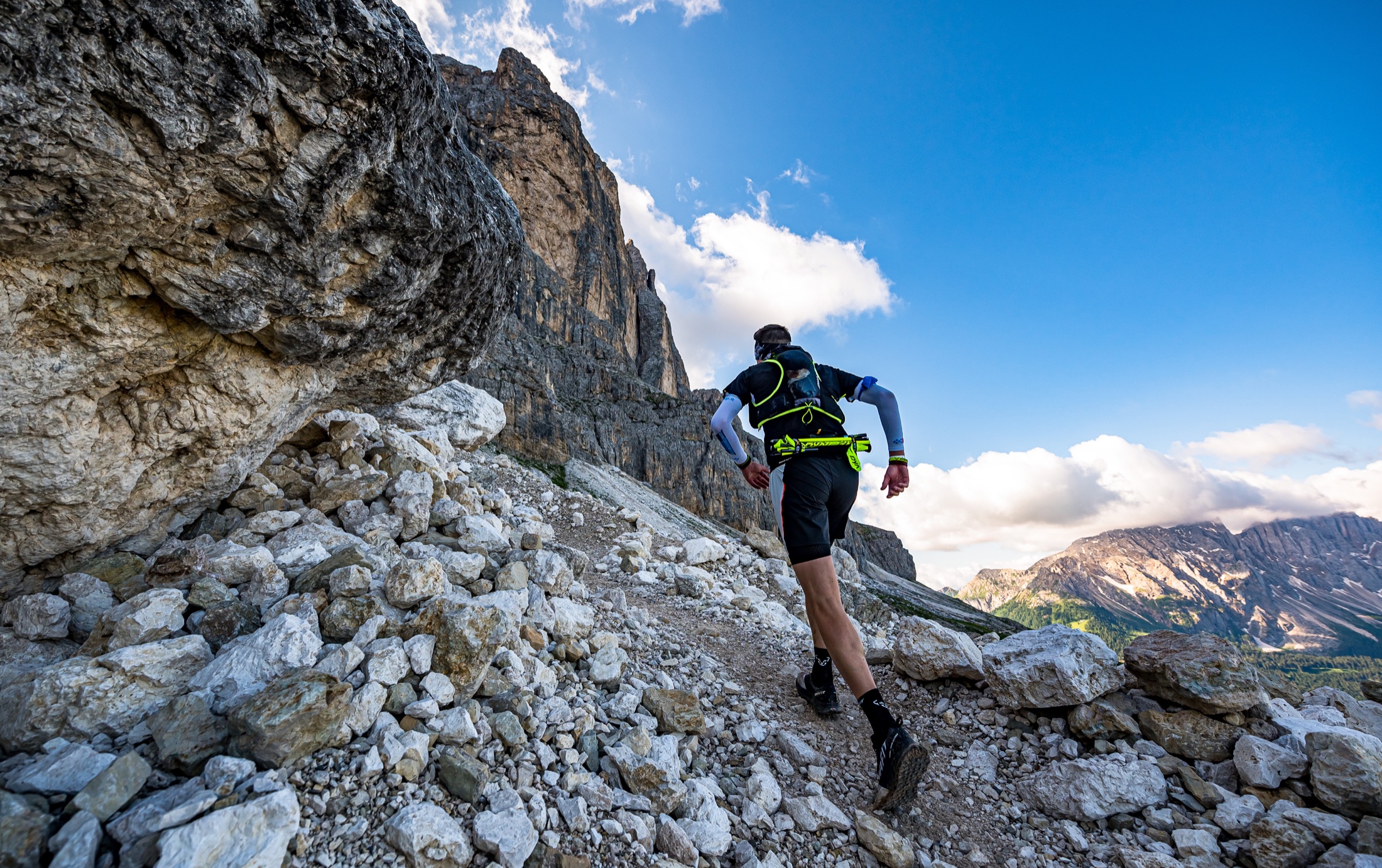Endurance runner climbing through mountain terrain